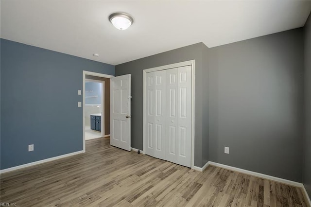 unfurnished bedroom with light hardwood / wood-style flooring and a closet