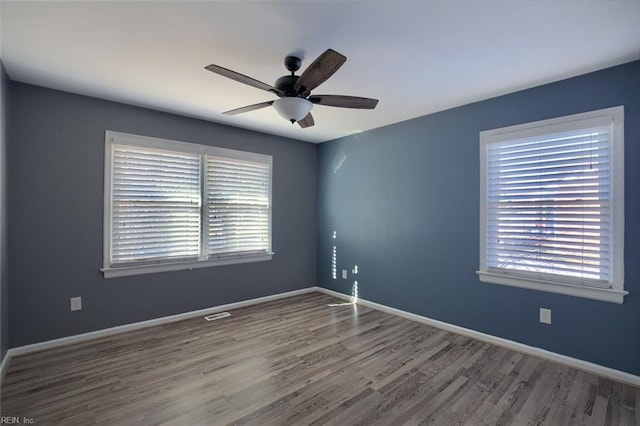 spare room with ceiling fan and hardwood / wood-style flooring