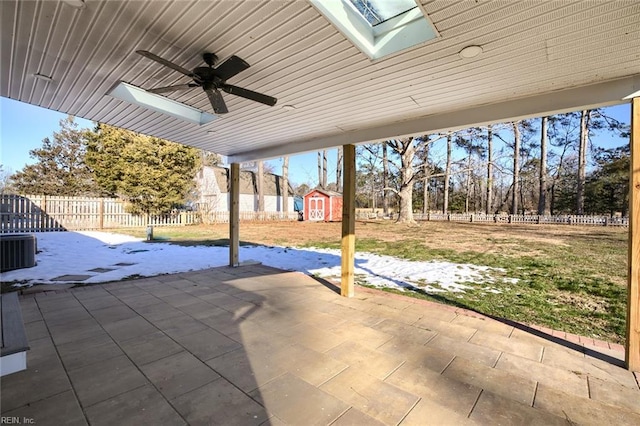 view of patio featuring central air condition unit, ceiling fan, and a storage shed