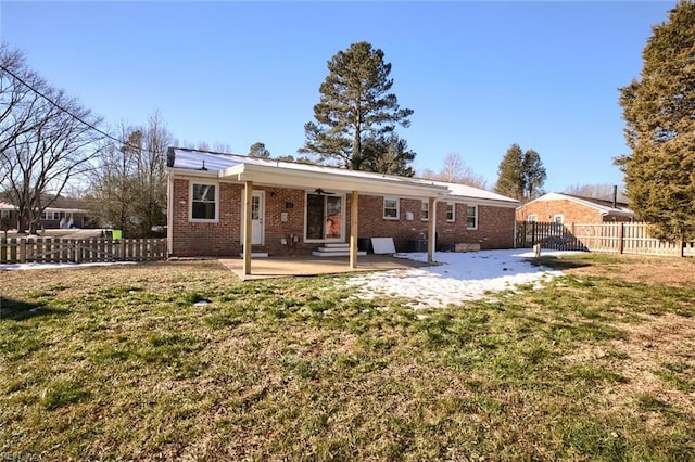 back of house with a patio and a lawn