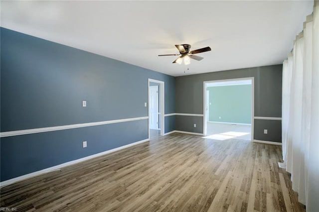 unfurnished room featuring ceiling fan and light hardwood / wood-style floors