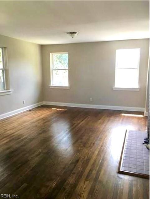 spare room featuring dark hardwood / wood-style flooring