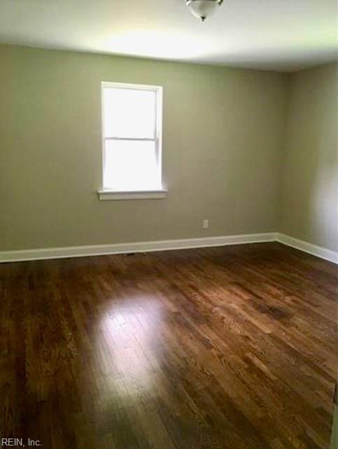 empty room featuring dark wood-type flooring