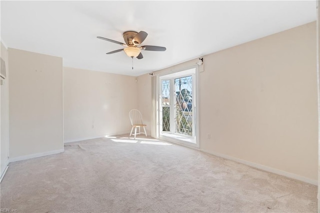 unfurnished room featuring ceiling fan and light colored carpet