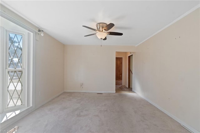 carpeted spare room with ceiling fan