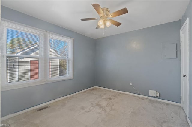 carpeted spare room featuring ceiling fan