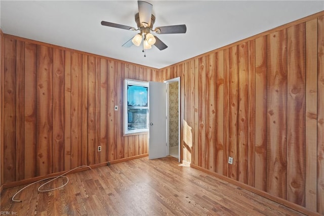 spare room with ceiling fan and wood-type flooring