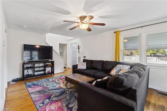 living room with ceiling fan and hardwood / wood-style flooring