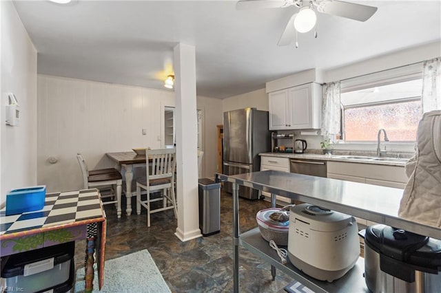 kitchen with sink, stainless steel appliances, white cabinetry, and ceiling fan