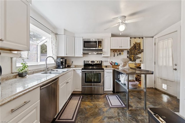 kitchen featuring appliances with stainless steel finishes, ceiling fan, white cabinetry, and sink