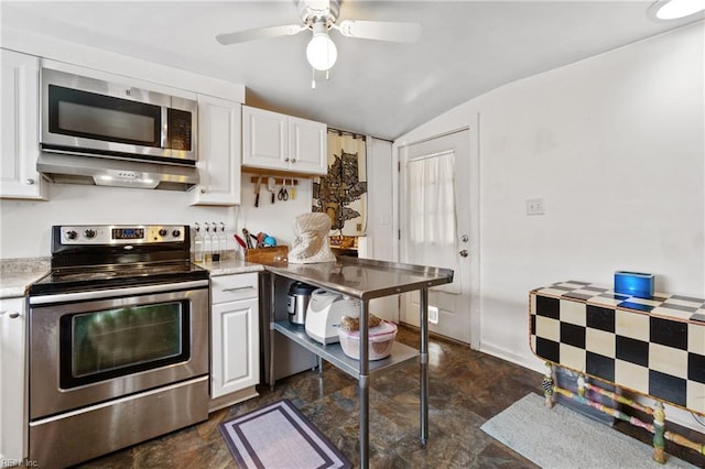 kitchen with stainless steel appliances, vaulted ceiling, and white cabinetry