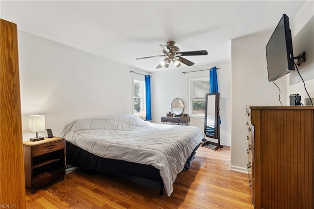 bedroom with hardwood / wood-style floors and ceiling fan