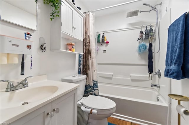 full bathroom with toilet, shower / tub combo with curtain, and vanity