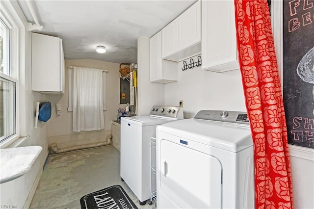 clothes washing area with independent washer and dryer and cabinets