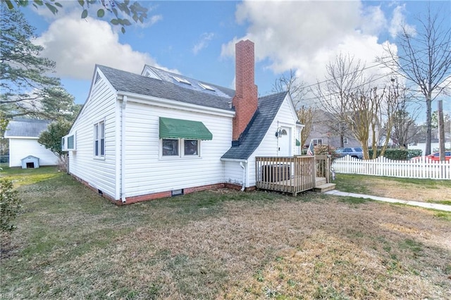 rear view of property featuring a deck and a yard