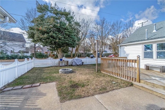 view of yard featuring a wooden deck, an outdoor fire pit, and a patio area