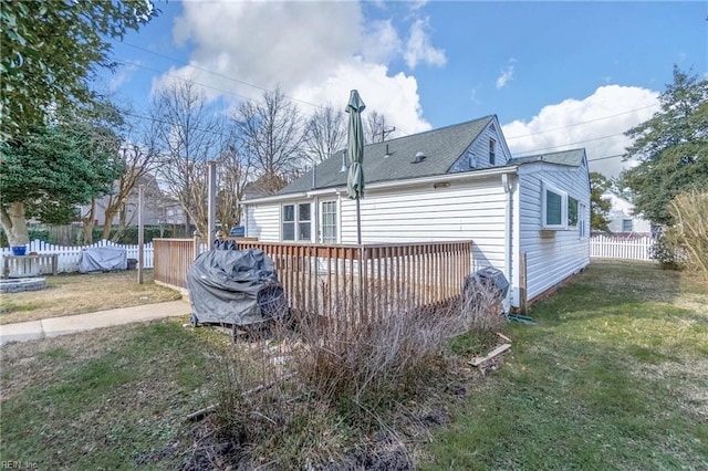 view of home's exterior with a yard and a wooden deck