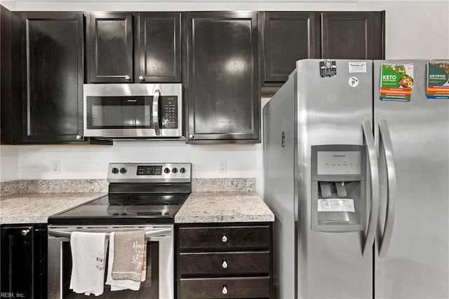 kitchen featuring stainless steel appliances and dark brown cabinetry