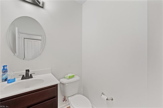 bathroom featuring toilet and vanity