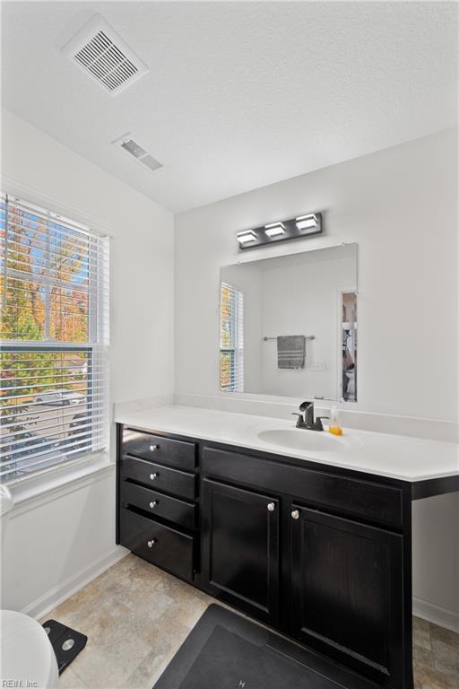 bathroom featuring toilet and vanity