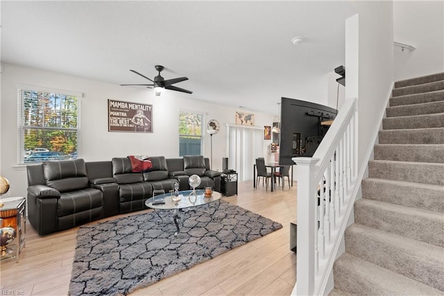 living room with ceiling fan and light wood-type flooring