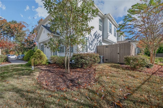 view of property exterior featuring a lawn and central AC unit