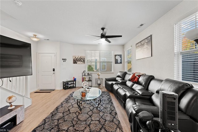 living room featuring ceiling fan and light hardwood / wood-style flooring