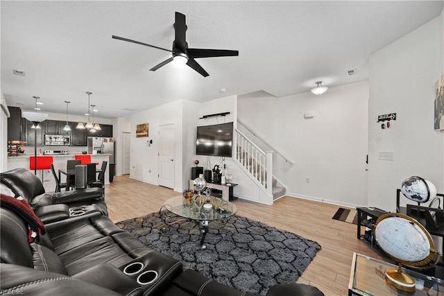 living room with ceiling fan and light wood-type flooring