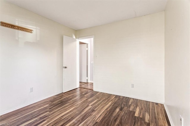 unfurnished room featuring dark hardwood / wood-style flooring