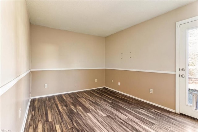 unfurnished room featuring dark hardwood / wood-style flooring