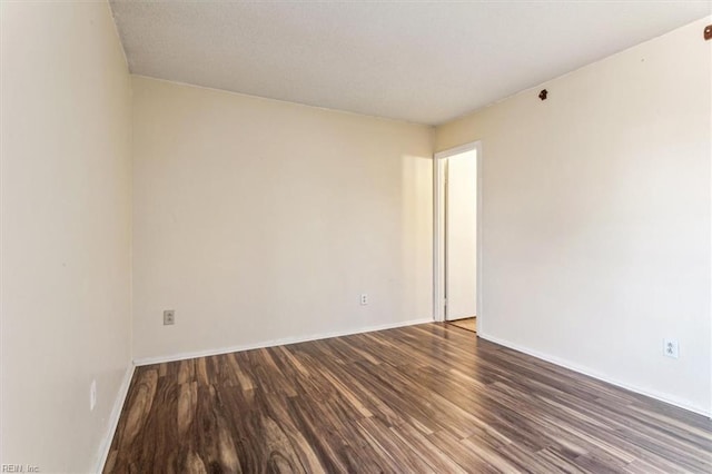 spare room featuring dark hardwood / wood-style flooring