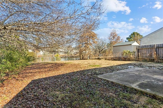 view of yard with a patio area and a water view