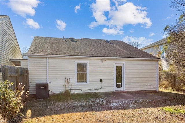 rear view of house with central AC and a patio area