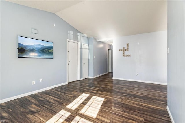 empty room with lofted ceiling and dark hardwood / wood-style floors