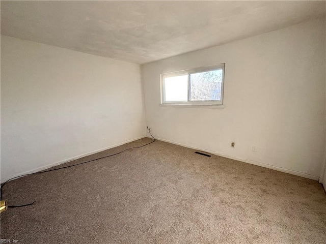 spare room featuring carpet