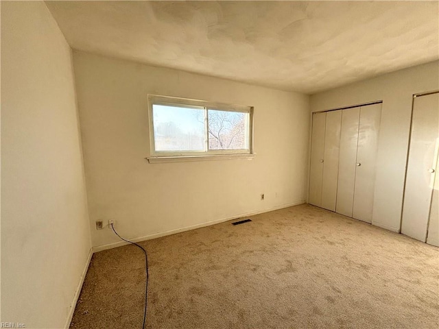 unfurnished bedroom featuring light colored carpet