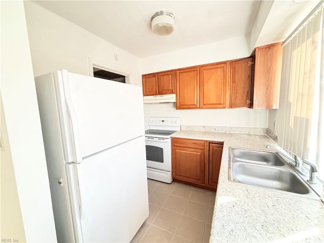 kitchen with sink, white appliances, and light tile patterned floors