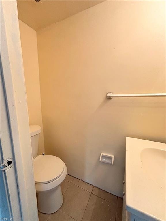 bathroom featuring toilet, tile patterned flooring, and vanity