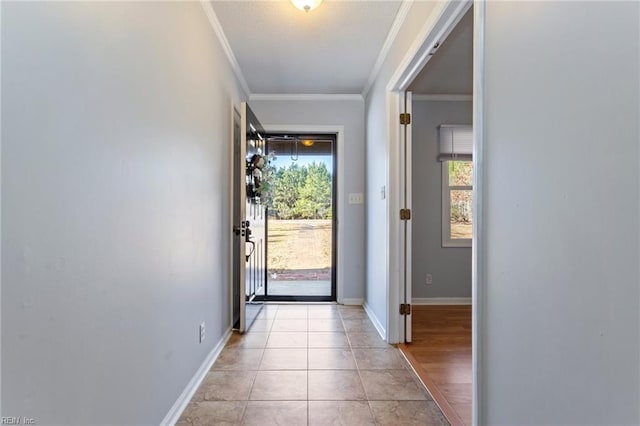 doorway to outside featuring plenty of natural light, light tile patterned floors, and ornamental molding