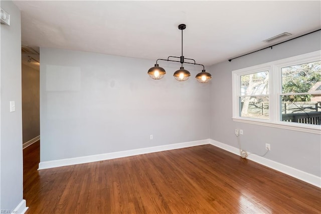 empty room with dark hardwood / wood-style floors