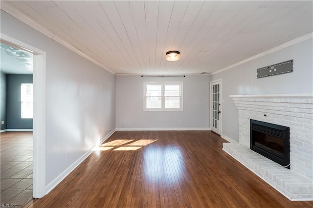 unfurnished living room featuring dark hardwood / wood-style flooring, a fireplace, ornamental molding, and wooden ceiling