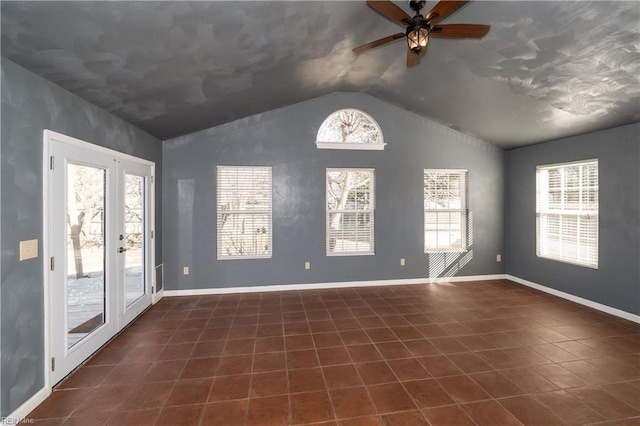 tiled spare room with lofted ceiling, french doors, ceiling fan, and plenty of natural light