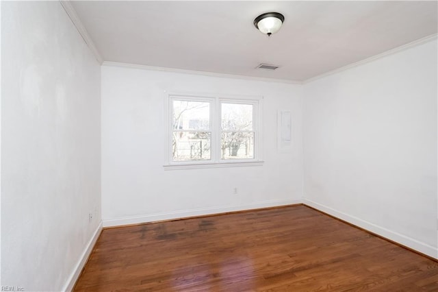 empty room with crown molding and dark hardwood / wood-style floors