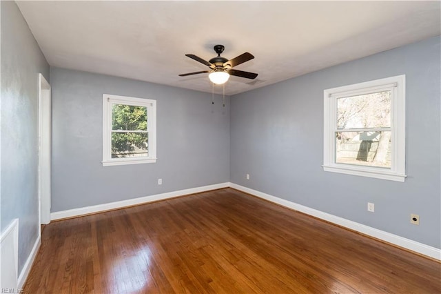 unfurnished room with dark hardwood / wood-style flooring and ceiling fan