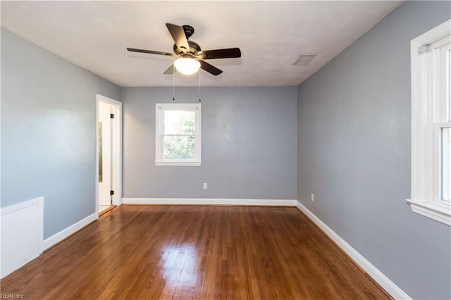 empty room featuring ceiling fan and dark hardwood / wood-style floors