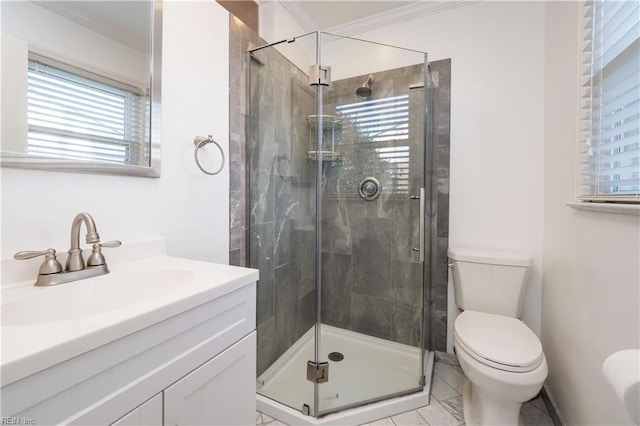 bathroom with tile patterned flooring, toilet, crown molding, vanity, and a shower with shower door