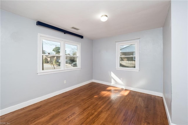 spare room with hardwood / wood-style flooring