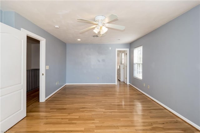 spare room featuring ceiling fan and light hardwood / wood-style flooring