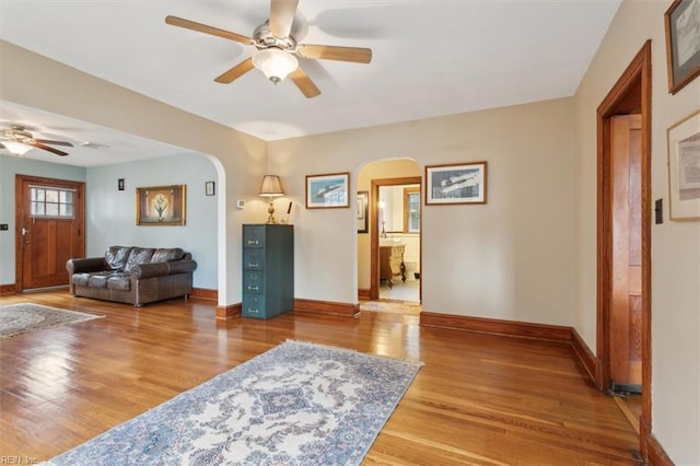 living room with ceiling fan and wood-type flooring