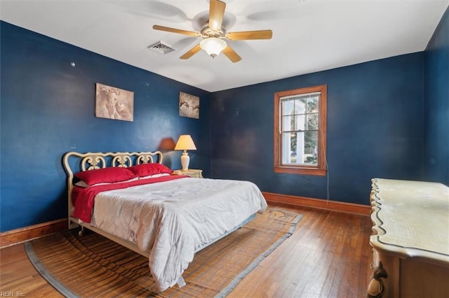 bedroom with ceiling fan and hardwood / wood-style flooring